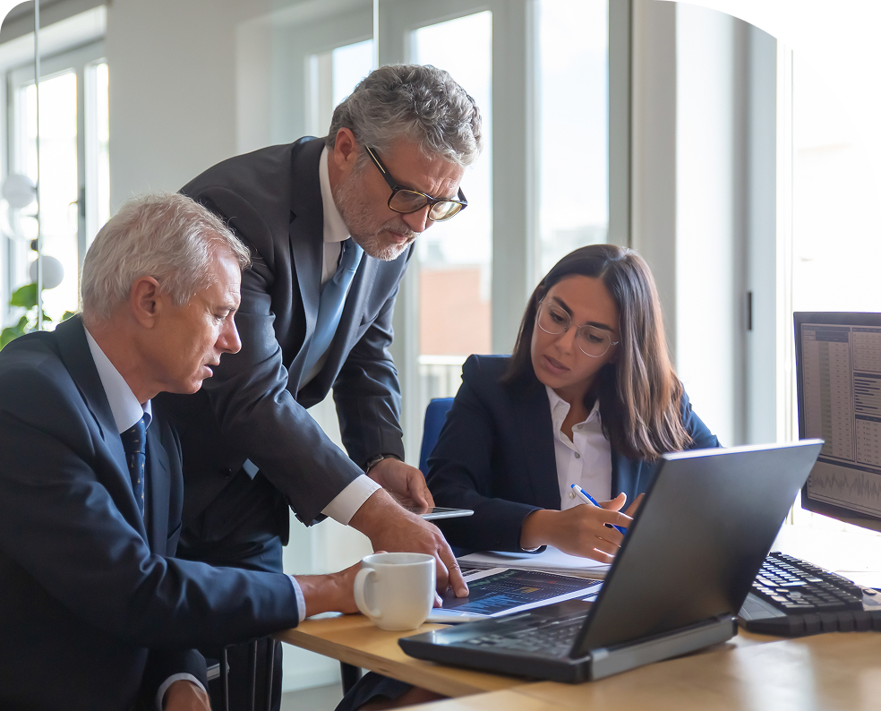 group sitting at a table working on a laptop